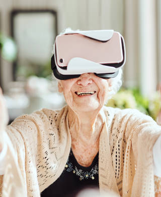 Shot of happy senior women using a virtual reality headset at a retirement home