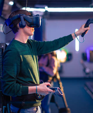 Young man and woman playing VR multiplayer video game. Entertainment club