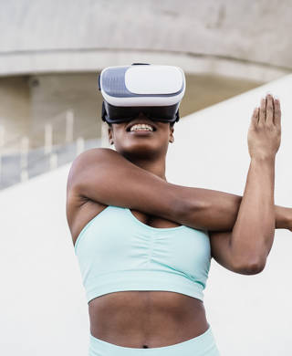 Fir african woman wearing virtual reality headset during sport workout routine - Focus on vr goggles