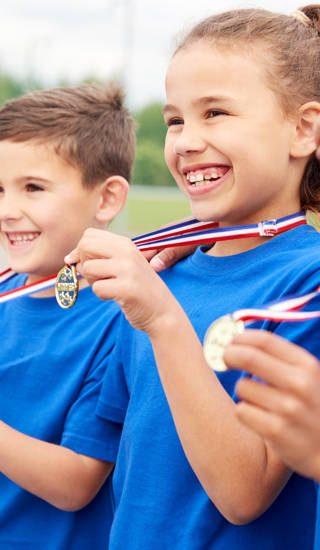 Children Showing Off Winners Medals On Sports Day