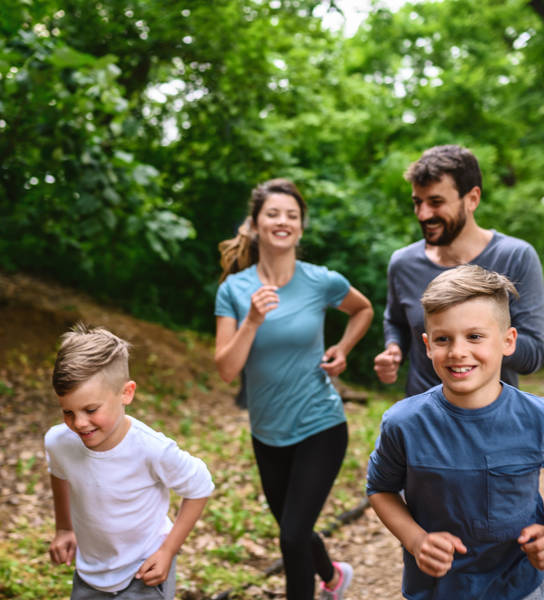 Portrait of happy family exercise running in the park spring time. Health care together love lifestyle concept